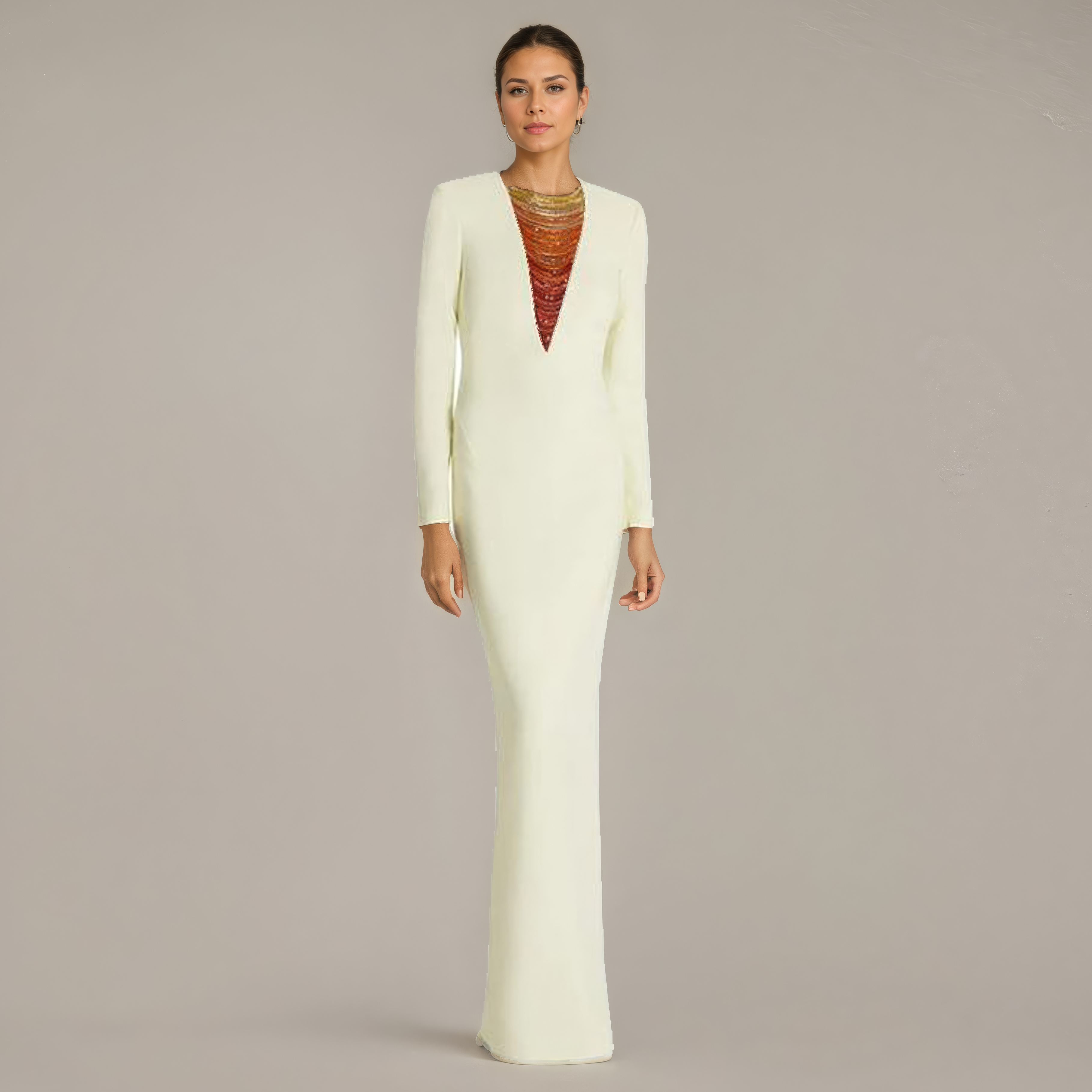 Woman wearing a long white dress with a fitted bodice and flared skirt on a plain background