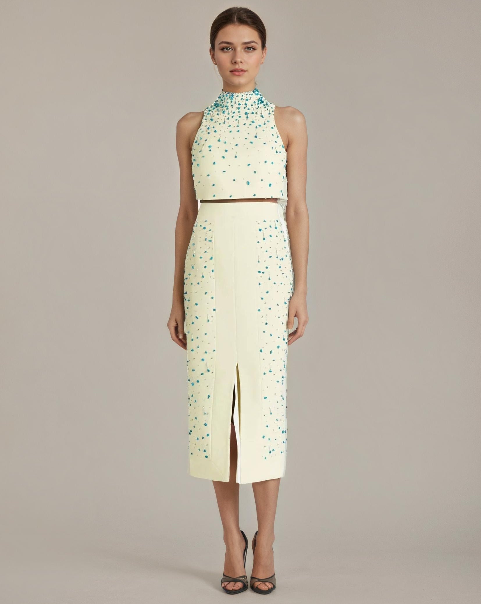 Woman wearing a light green dress with floral patterns on a white background