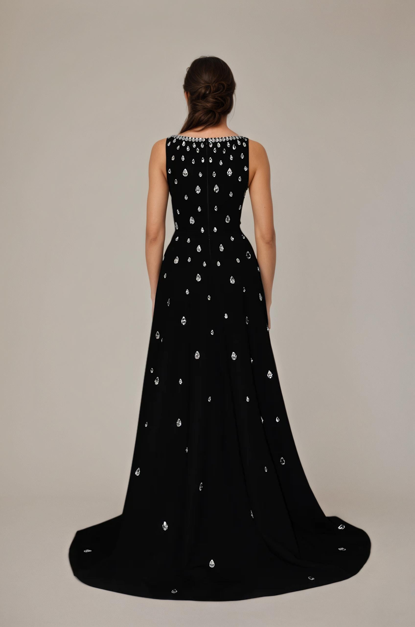 Black evening gown with silver embellishments on a plain background