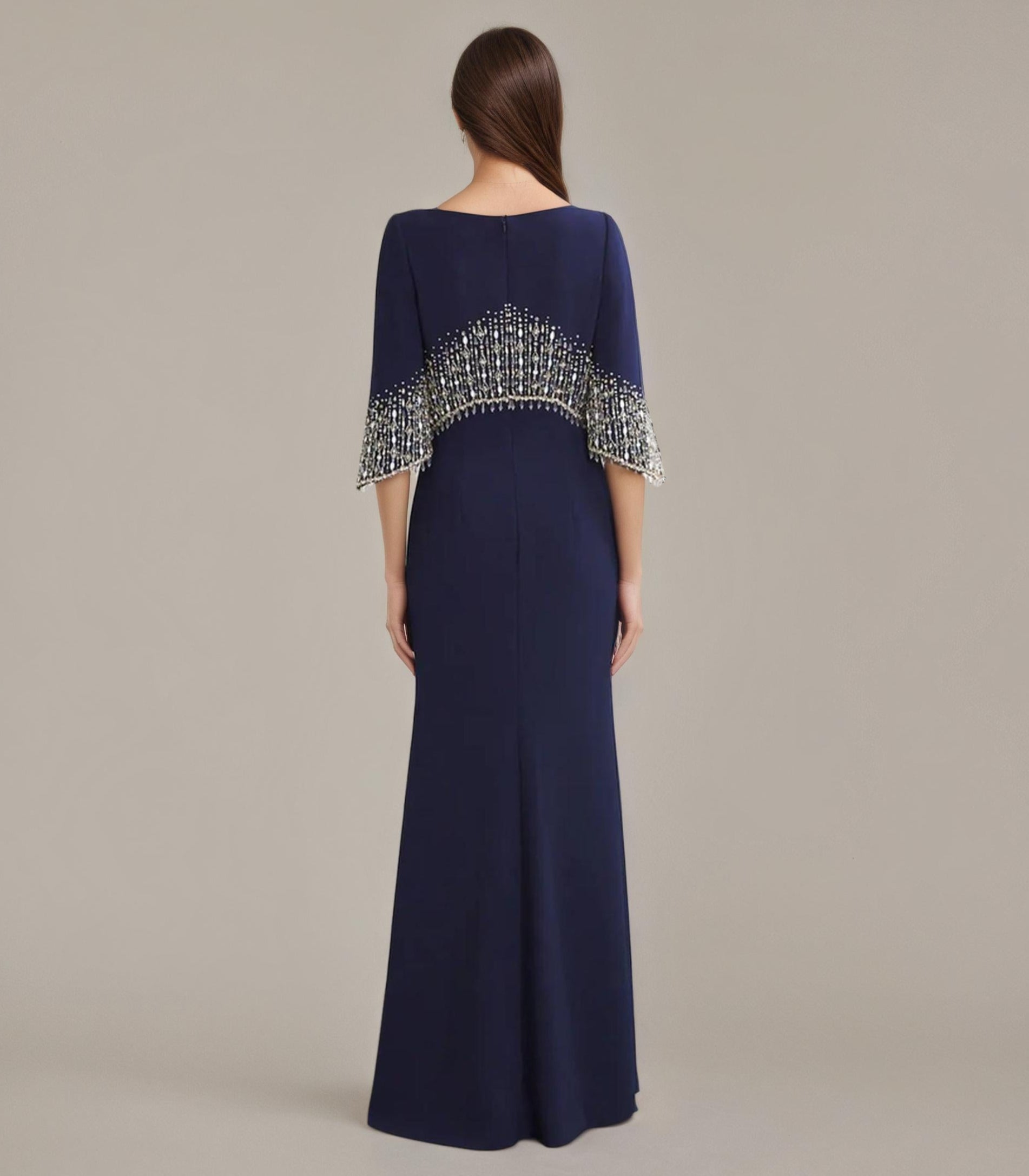 Navy blue evening gown with beaded detailing on a plain background