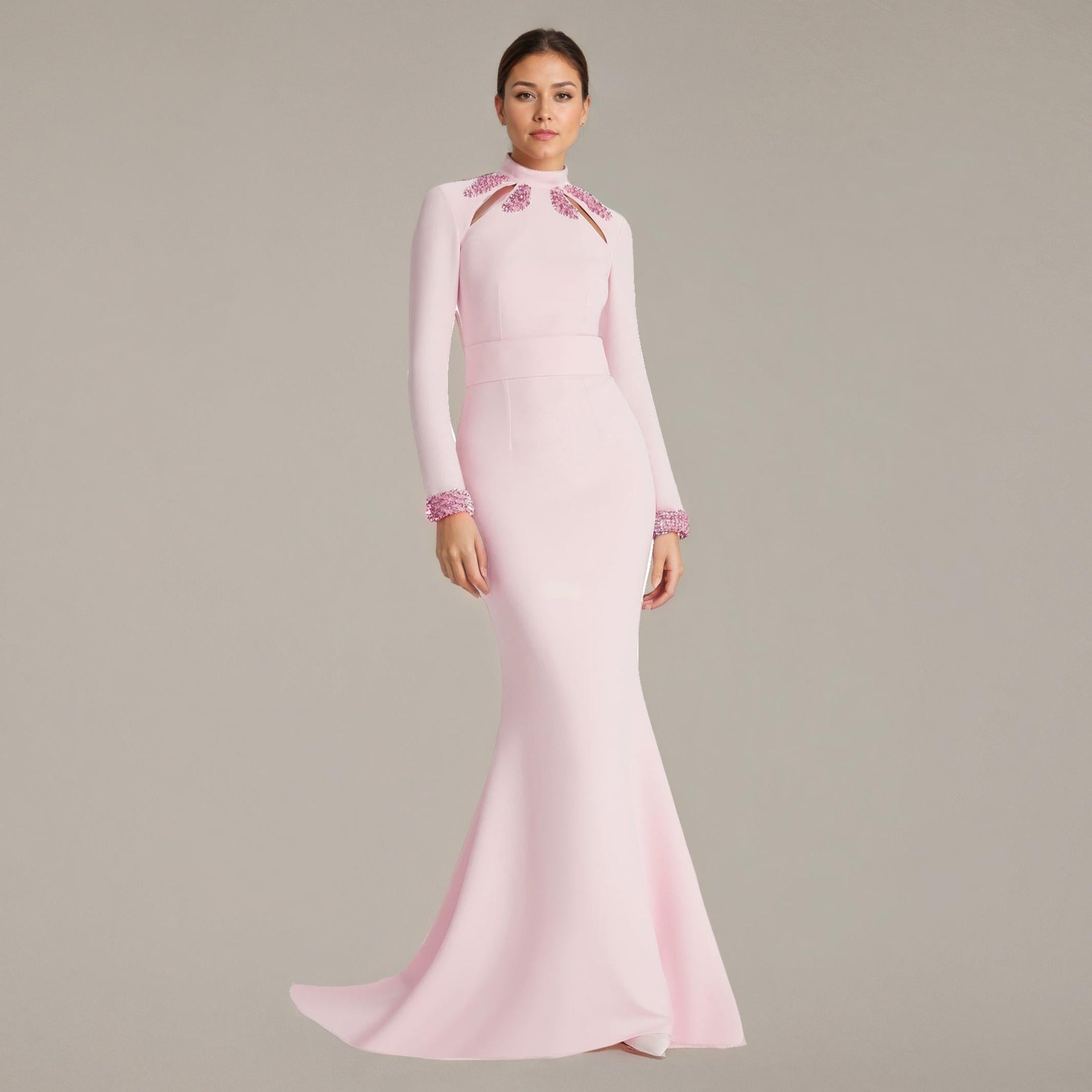 Pink evening gown with intricate detailing on a plain background