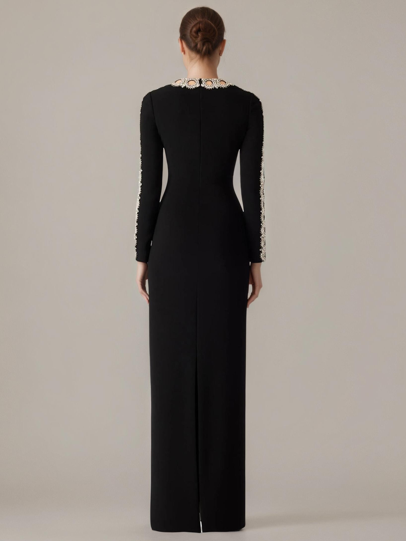 Black evening gown with long sleeves and a high neckline on a plain background