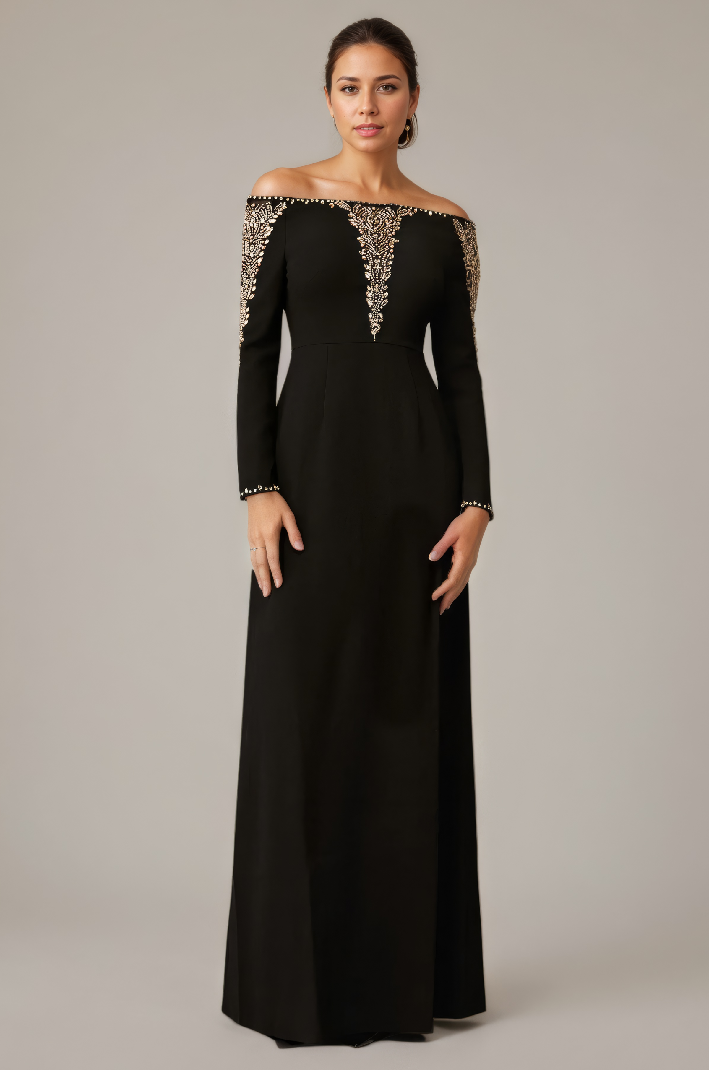 Woman wearing a black off-shoulder evening gown with gold embellishments on a neutral background