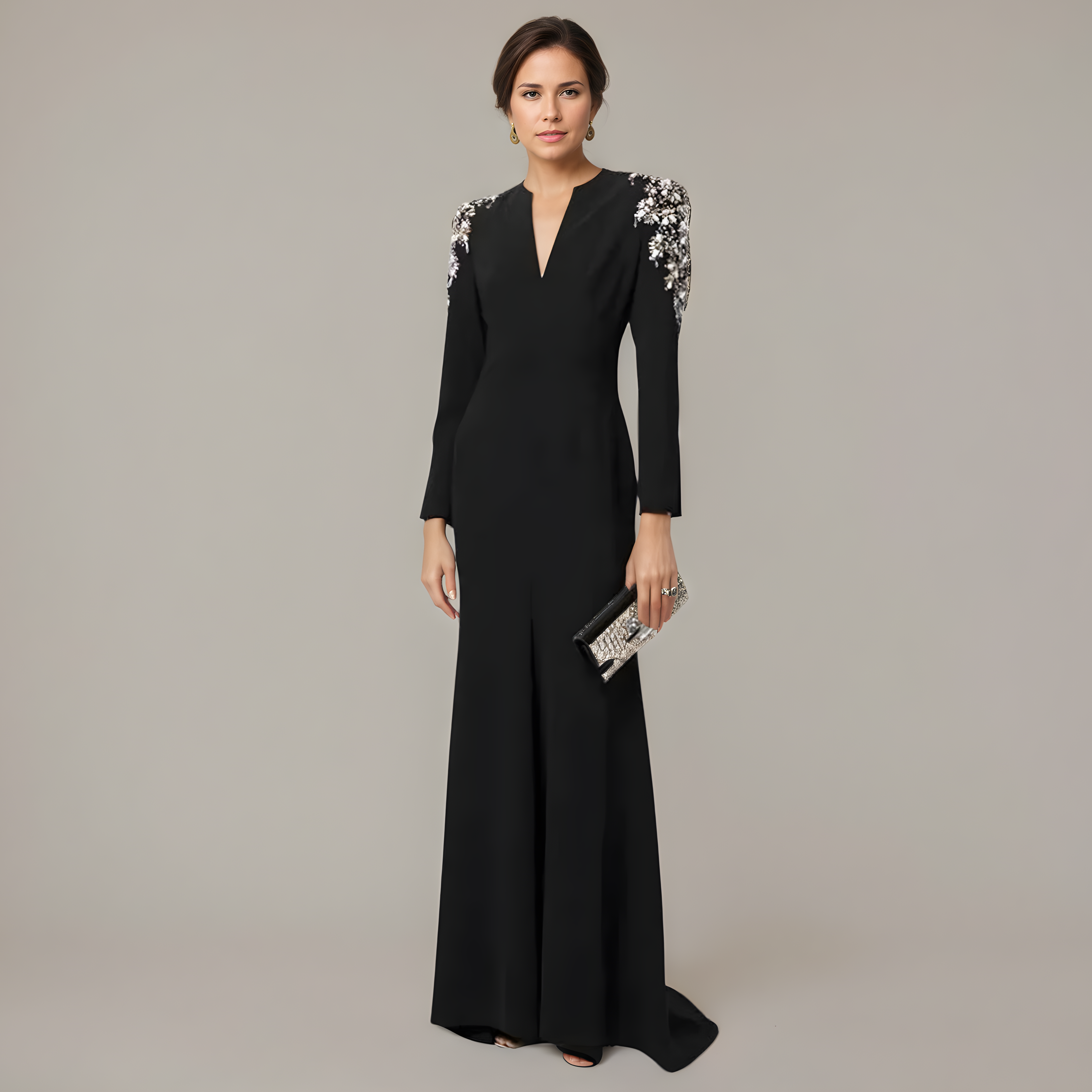 Woman wearing a black evening gown with floral embellishments on a plain background