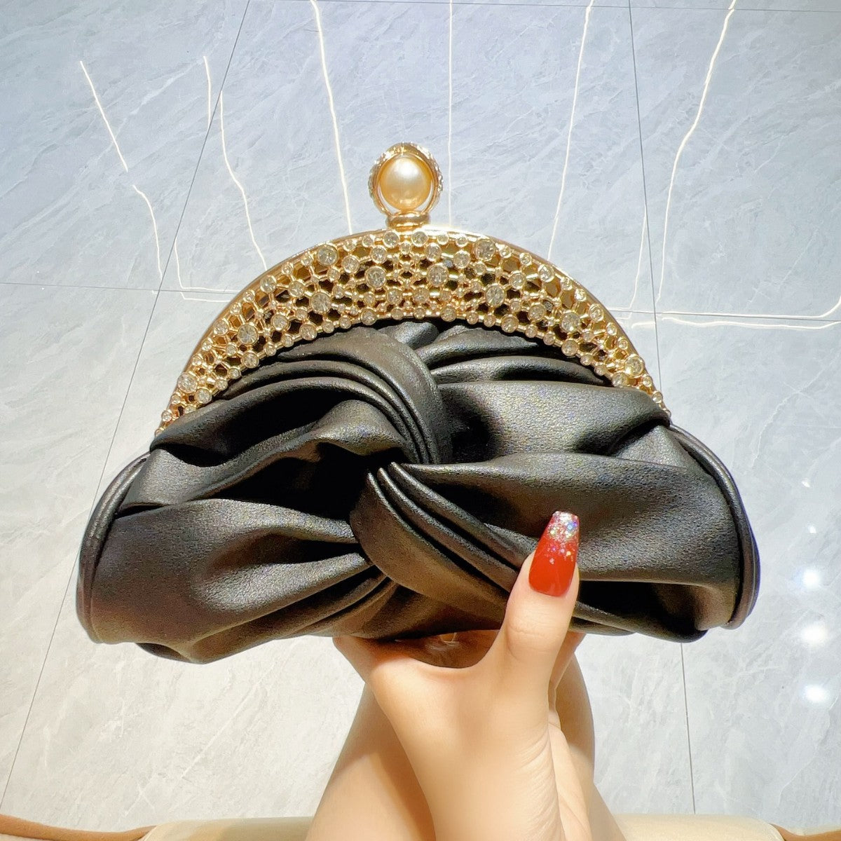 Diamond-Encrusted Pleated Clutch with Pearl Clasp — close-up detail