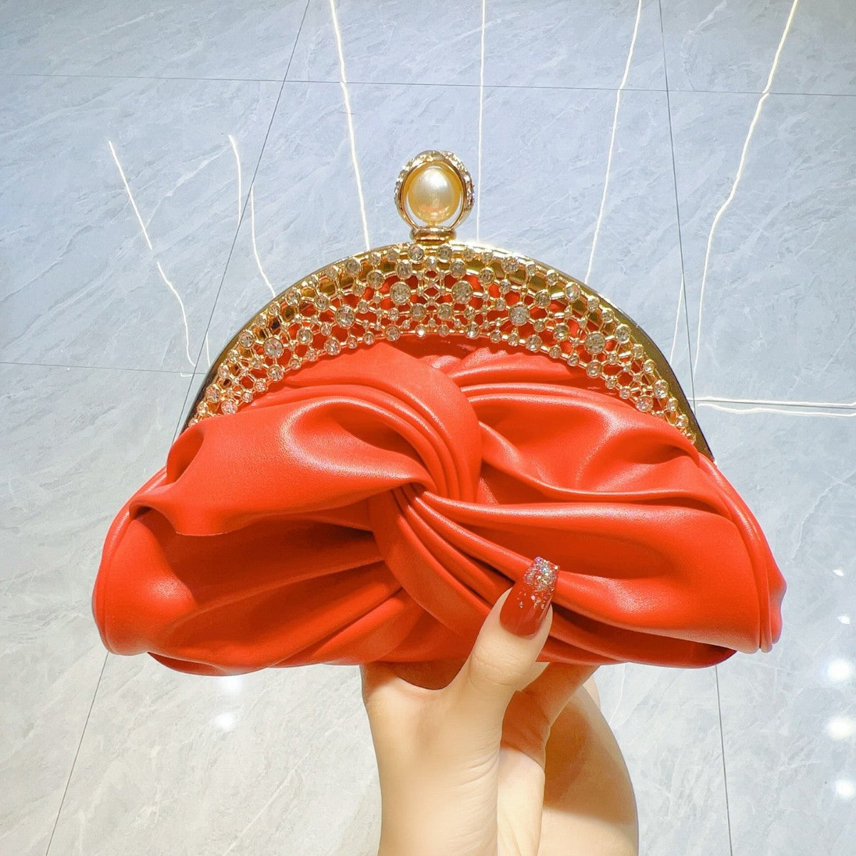 Diamond-Encrusted Pleated Clutch with Pearl Clasp — runway angle