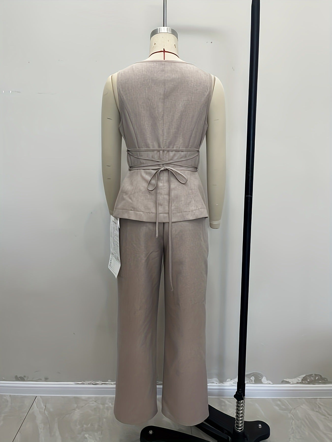 Philippine button vest and wide-leg trouser set in grey — back view on mannequin with tie detail
