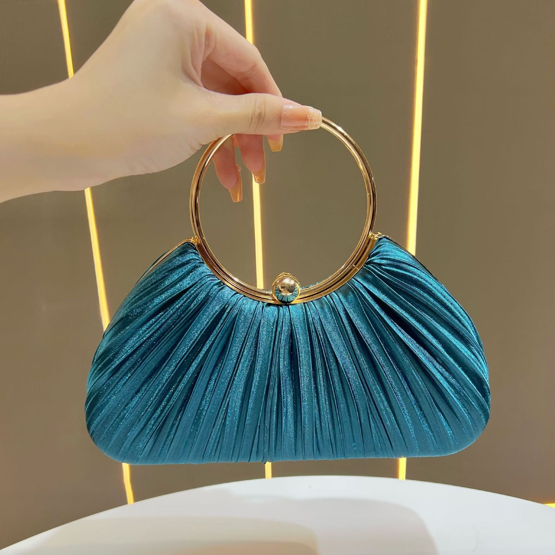 Pleated Satin Evening Bag with Gold Ring Handle — neckline detail