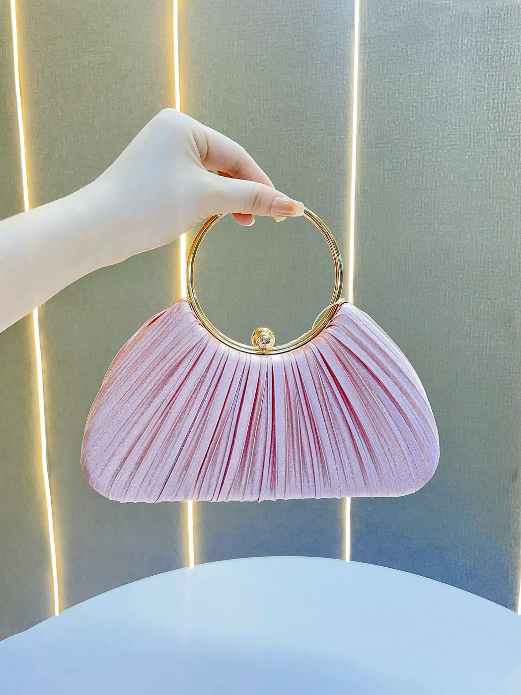 Pleated Satin Evening Bag with Gold Ring Handle — styled look