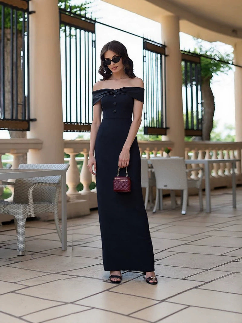 Black off-shoulder buttoned column dress on a terrace