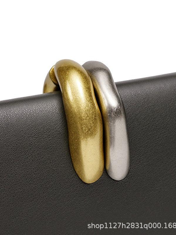 Sculptural Two-Tone Clasp Evening Clutch — styled look